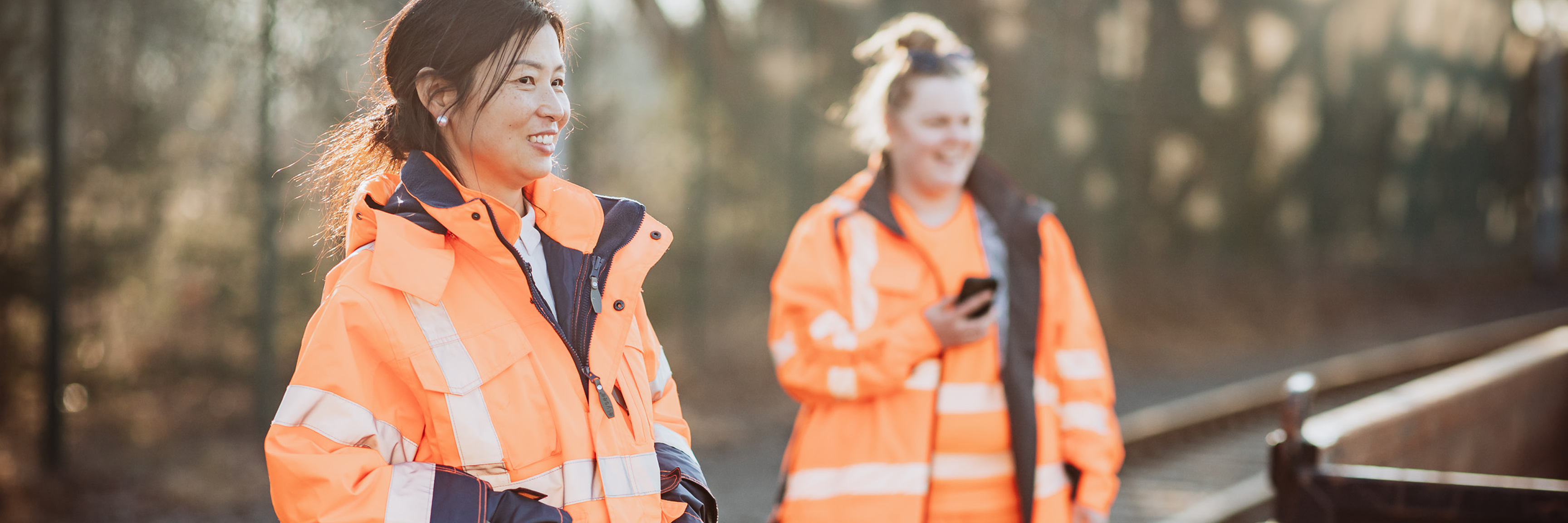 2 smiling women in work clothes