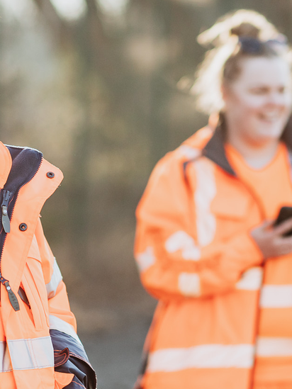 2 smiling women in work clothes